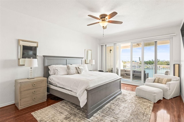3805 Gulf Blvd Unit 404, St Pete Beach, FL 33706 - bedroom featuring access to exterior, dark wood finished floors, and a ceiling fan