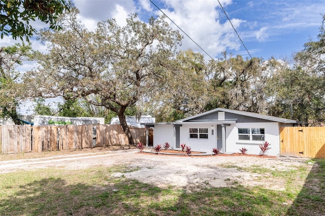 view of front of house featuring fence and stucco siding