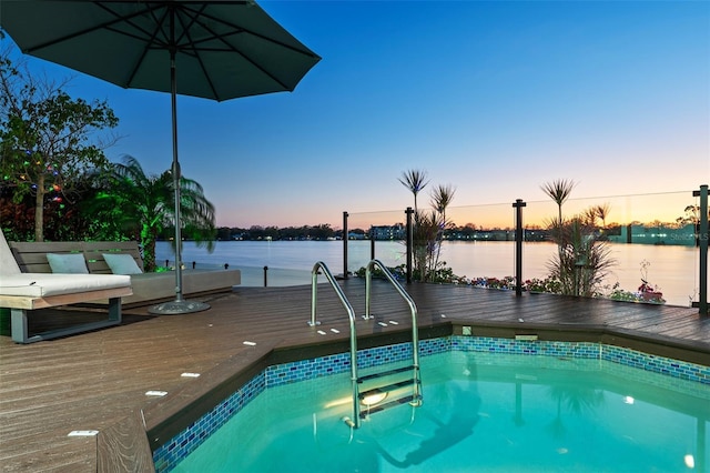 pool at dusk with a deck