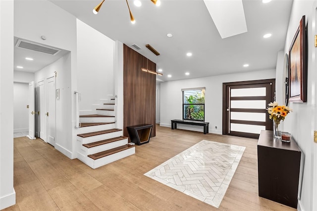 foyer with light wood-style floors, stairs, visible vents, and recessed lighting