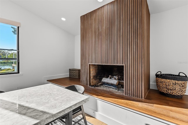 bedroom featuring a fireplace, vaulted ceiling, and recessed lighting