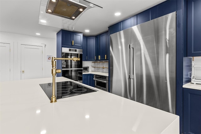 kitchen with high end fridge, blue cabinetry, light countertops, and black electric cooktop