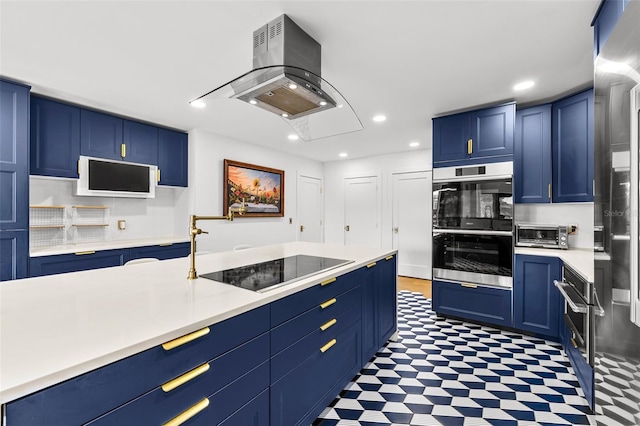 kitchen with recessed lighting, island range hood, light countertops, blue cabinetry, and tile patterned floors