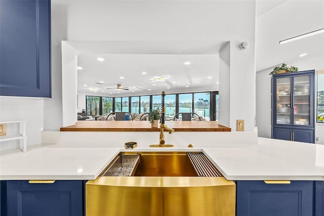 kitchen with light countertops and blue cabinetry