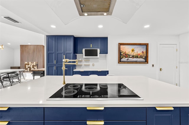 kitchen featuring black electric stovetop, recessed lighting, blue cabinets, visible vents, and light countertops