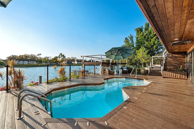 outdoor pool with a deck with water view