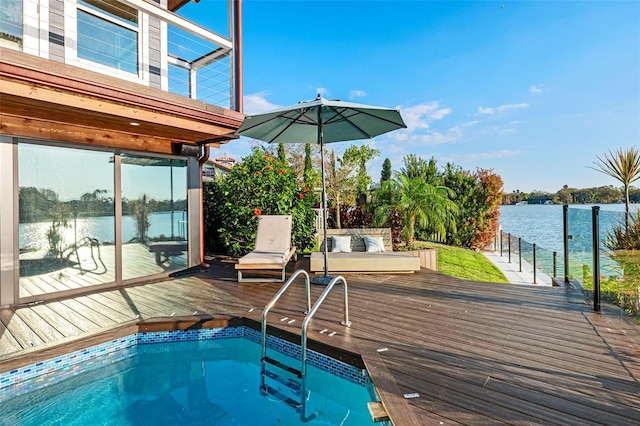 view of swimming pool with a deck with water view and an in ground hot tub