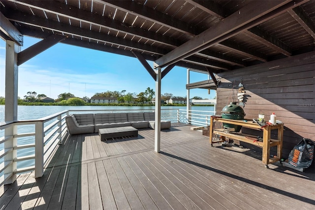 wooden terrace with outdoor lounge area and a water view