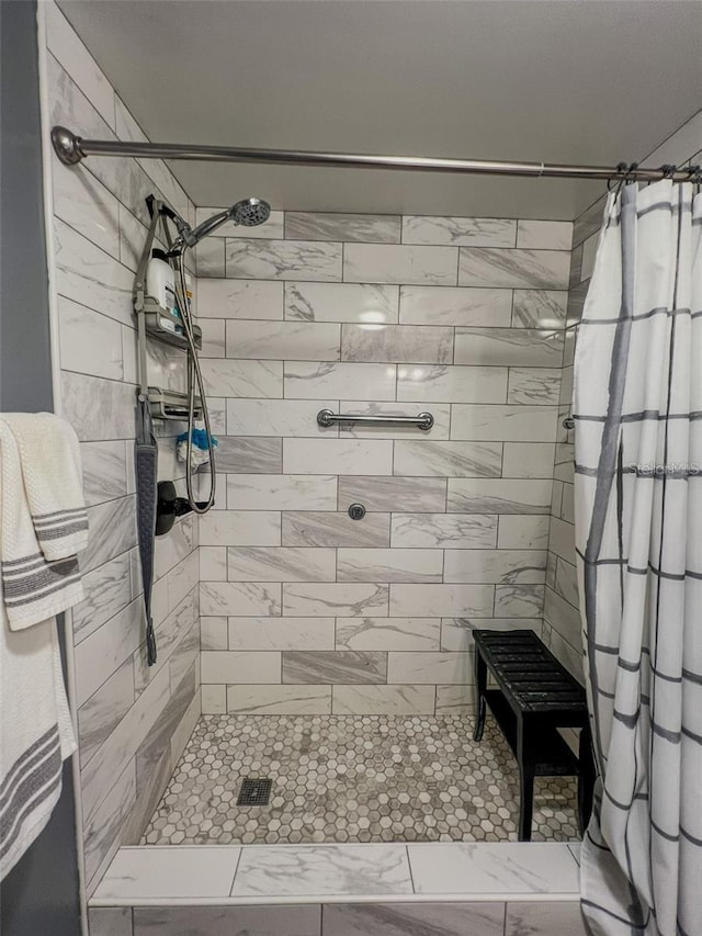 full bathroom with a tile shower