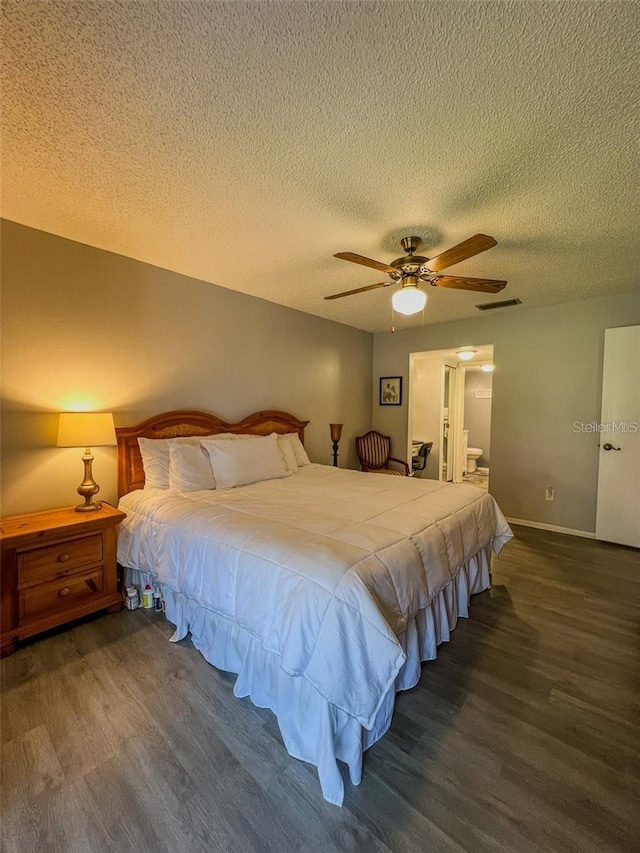 bedroom featuring visible vents, ceiling fan, connected bathroom, a textured ceiling, and wood finished floors