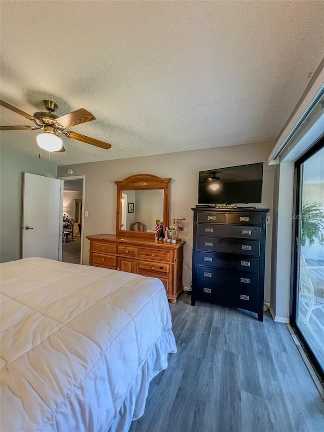 bedroom with a textured ceiling, ceiling fan, wood finished floors, and access to exterior