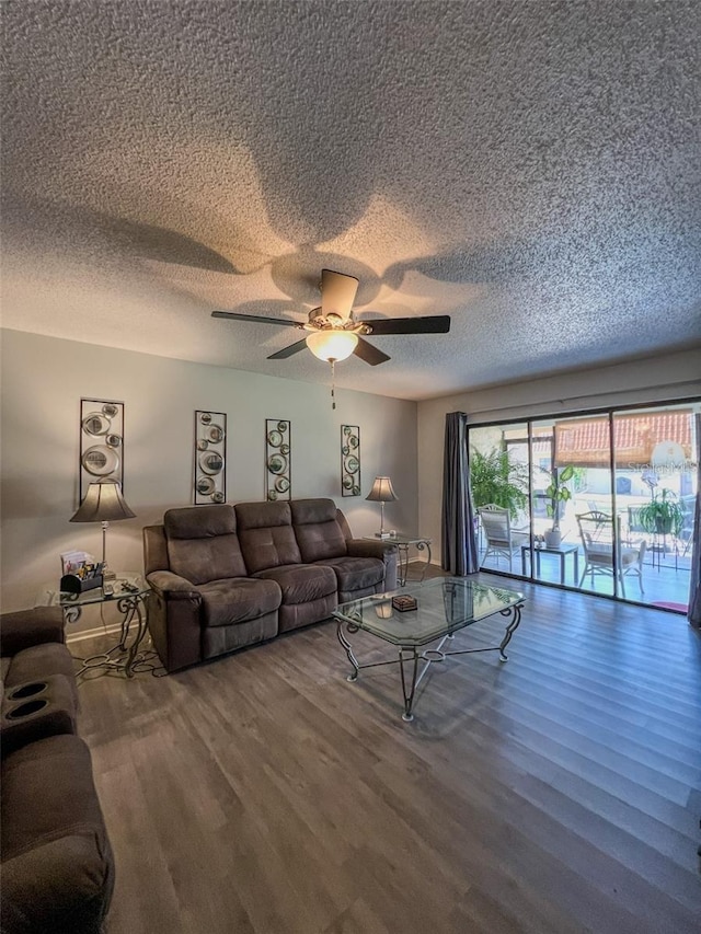 living area featuring ceiling fan, a textured ceiling, and wood finished floors