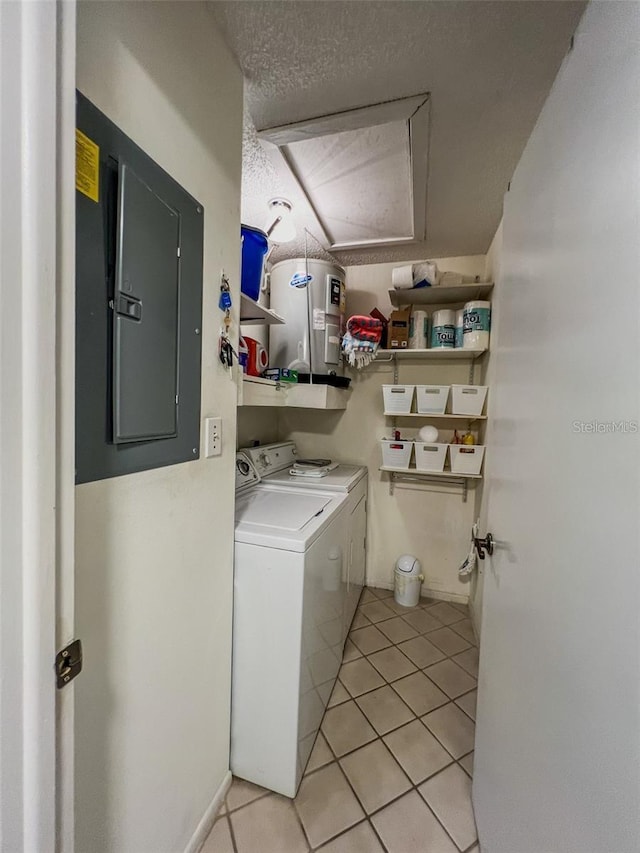 laundry room with washing machine and clothes dryer, light tile patterned flooring, a textured ceiling, laundry area, and electric panel