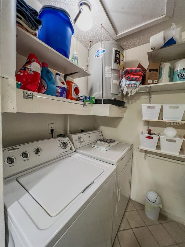 laundry room with light tile patterned floors, laundry area, and washing machine and dryer