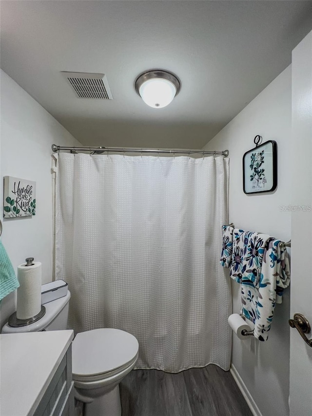 full bath featuring toilet, curtained shower, wood finished floors, and visible vents