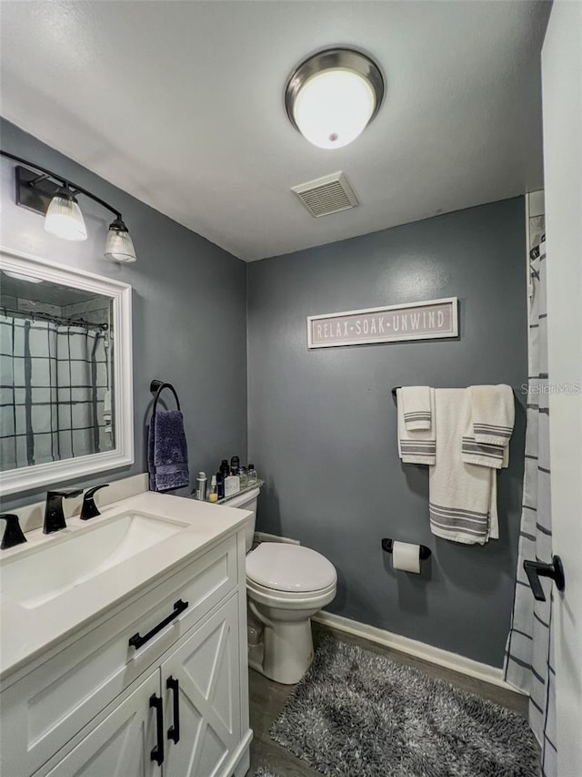 full bath featuring toilet, vanity, visible vents, baseboards, and a shower with curtain