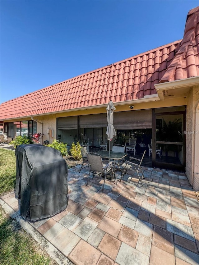 view of patio with a grill and outdoor dining area