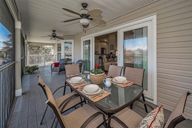 wooden deck featuring ceiling fan and outdoor dining space