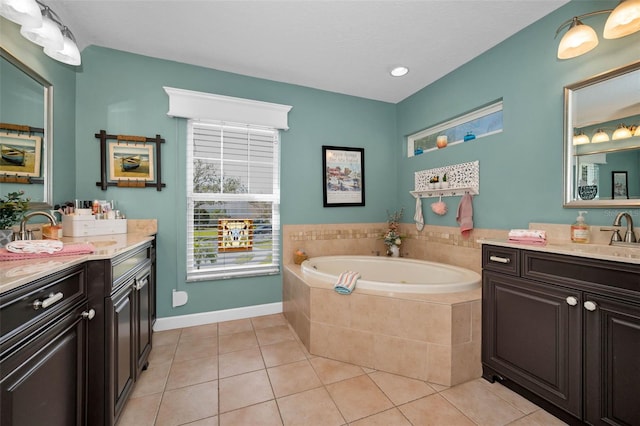 full bathroom with a garden tub, vanity, and tile patterned floors