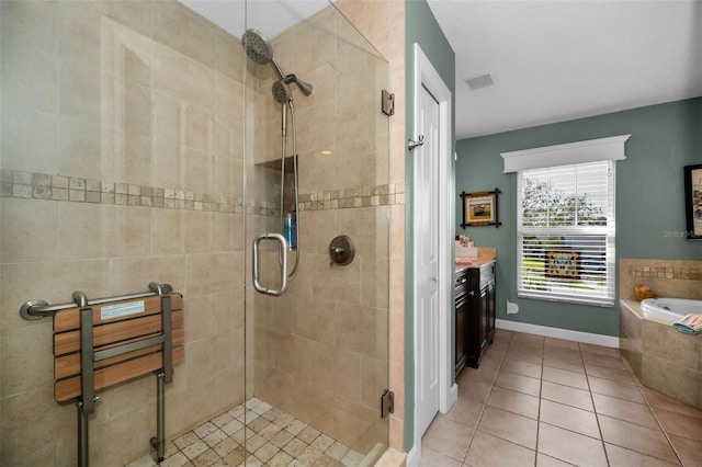 full bathroom featuring visible vents, vanity, a shower stall, a bath, and tile patterned floors