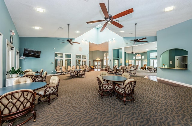 interior space with carpet, visible vents, high vaulted ceiling, and baseboards