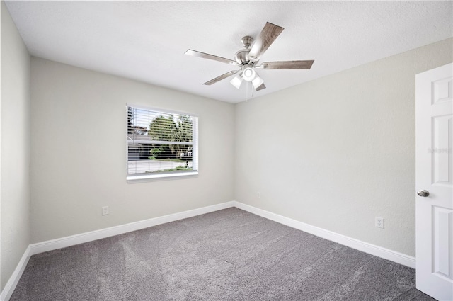 carpeted spare room featuring a ceiling fan, a textured ceiling, and baseboards