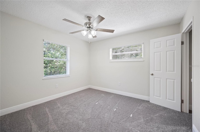 unfurnished bedroom featuring a textured ceiling, carpet flooring, a ceiling fan, and baseboards