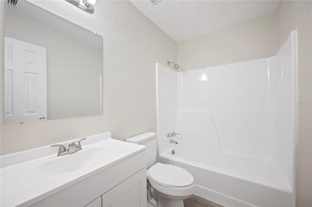 bathroom featuring bathtub / shower combination, vanity, and toilet