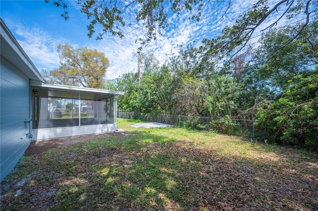 view of yard with a fenced backyard and a sunroom