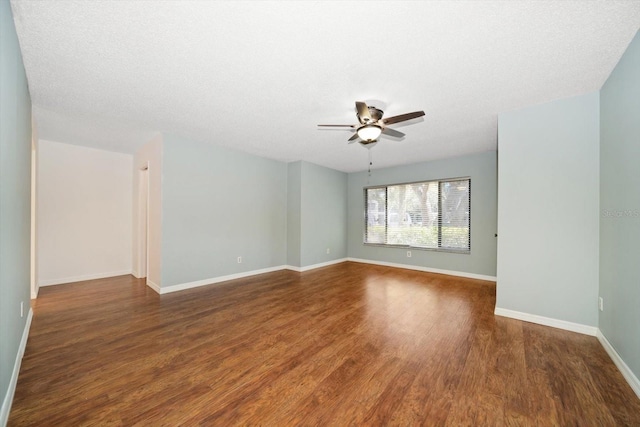 empty room featuring baseboards, a textured ceiling, wood finished floors, and a ceiling fan