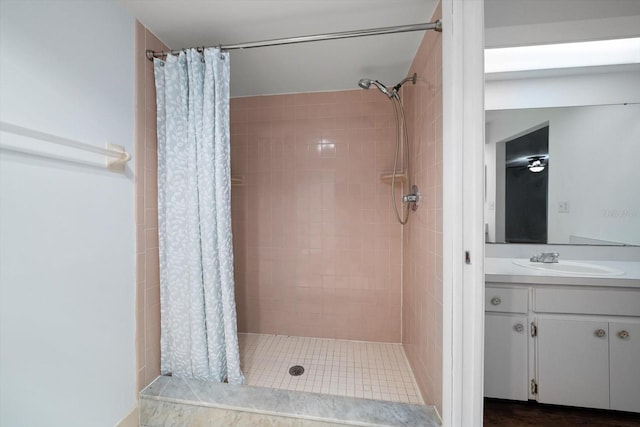 bathroom featuring a stall shower and vanity