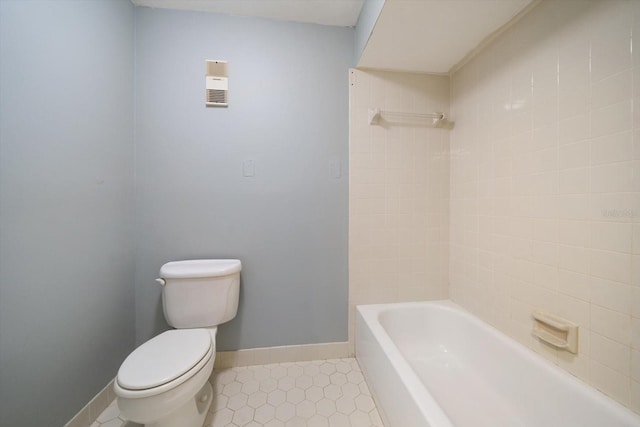 full bathroom featuring tile patterned floors, toilet, baseboards, and  shower combination