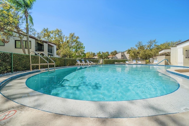 community pool featuring fence