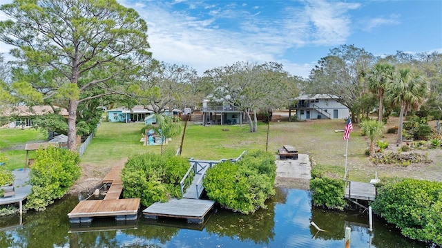 dock area featuring a water view and a lawn