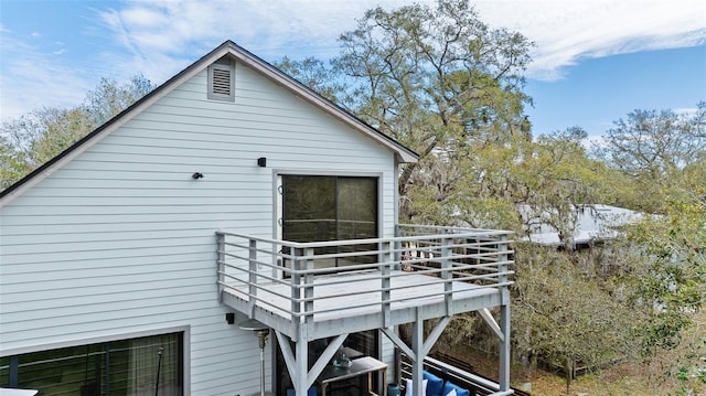 view of property exterior featuring a wooden deck