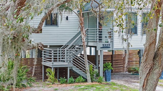 rear view of house featuring stairway