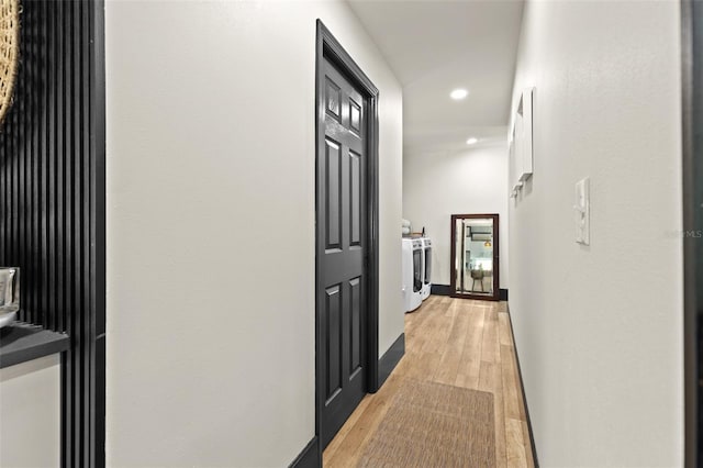 hall with washing machine and dryer, baseboards, light wood-style flooring, and recessed lighting