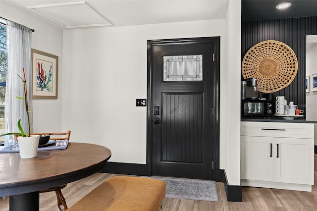 foyer entrance featuring light wood-style floors and baseboards