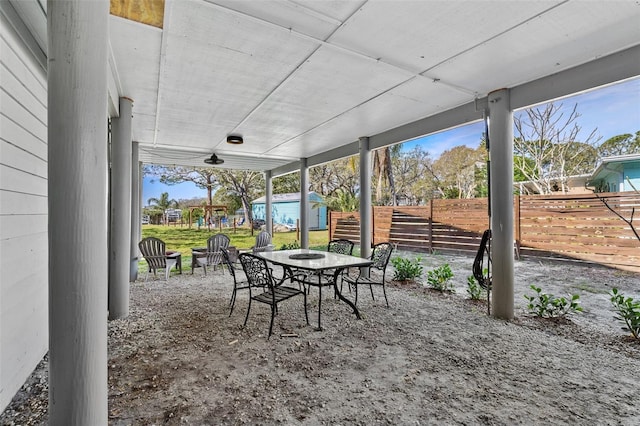 view of patio featuring outdoor dining space and fence