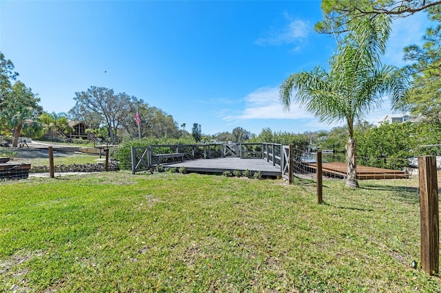 dock area featuring a yard and a wooden deck