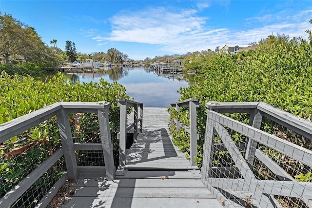 exterior space with a boat dock and a water view