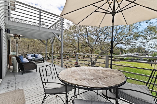 wooden terrace featuring outdoor dining area and an outdoor hangout area