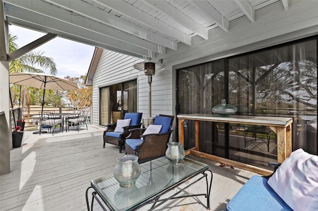 wooden terrace with outdoor dining area