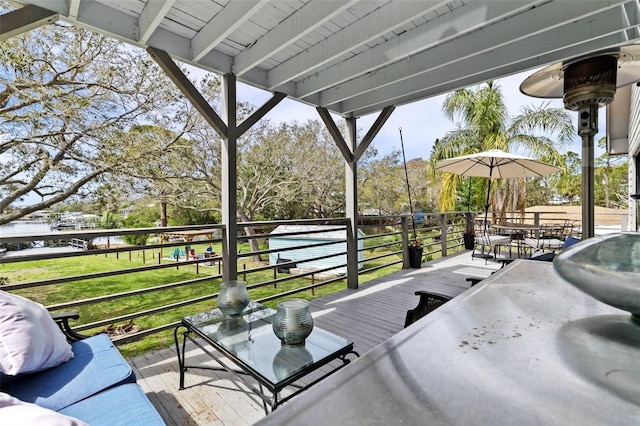 view of patio with a balcony and outdoor dining area