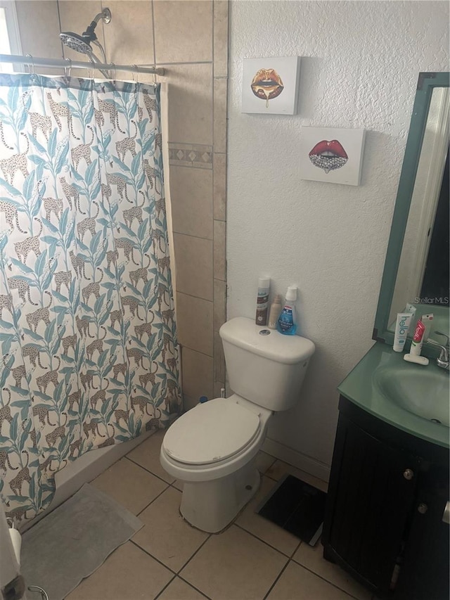 full bath featuring a shower with curtain, vanity, toilet, and tile patterned floors