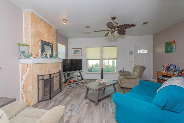313 Jefferson Ave S, Oldsmar, FL 34677 - living room with visible vents, a tile fireplace, ceiling fan, and wood finished floors