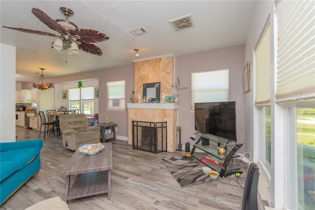 313 Jefferson Ave S, Oldsmar, FL 34677 - living room with light wood finished floors, visible vents, and a fireplace