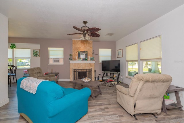 313 Jefferson Ave S, Oldsmar, FL 34677 - living room with a ceiling fan, baseboards, wood finished floors, visible vents, and a large fireplace