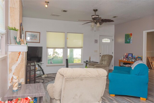 313 Jefferson Ave S, Oldsmar, FL 34677 - living area with ceiling fan, visible vents, a textured ceiling, and wood finished floors
