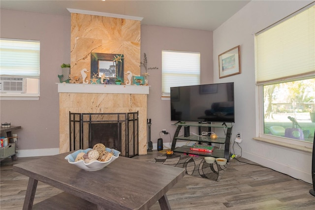 313 Jefferson Ave S, Oldsmar, FL 34677 - living area with cooling unit, baseboards, wood finished floors, and a tile fireplace